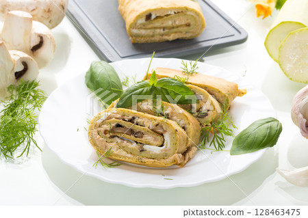Zucchini roll with cheese and mushrooms, isolated on a white background Zucchini roll with cheese and mushrooms, isolated on a white background 128463475
