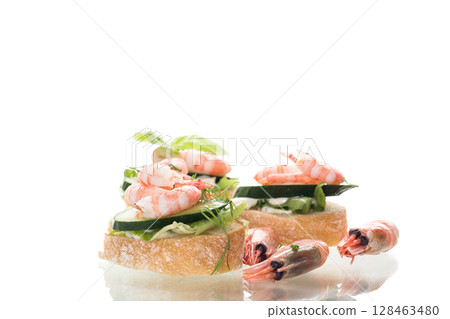 Delicious portioned appetizers with shrimps and greens on a white background 128463480