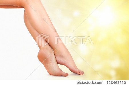 Beautiful female legs against an abstract background with sun flares and copyspace Beautiful female legs against an abstract background with sun flares and copyspace 128463530