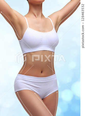 Dotted lines on beautiful female body. Closeup of woman slim fit body with white marks 128463532