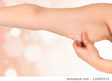 Woman holding her hand with excess fat against an abstract background with light flares and copyspace 128463533