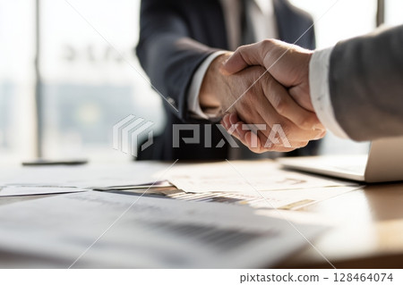 Handshake between business professionals partnership, agreement, trust, collaboration, commitment, and corporate success in strategic business context 128464074