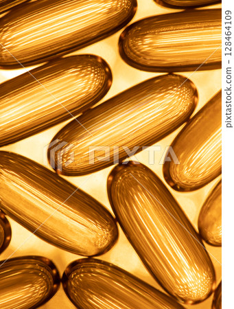 Close-up of shiny yellow vitamin capsules, healthy concept 128464109