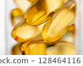 Close-up of shiny yellow vitamin capsules, healthy concept 128464116