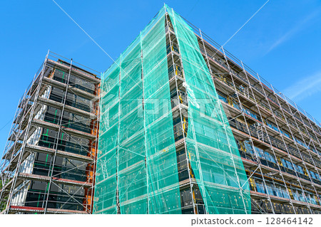 Multi-story building facade thermal insulation installation and renovation, scaffold and netting 128464142