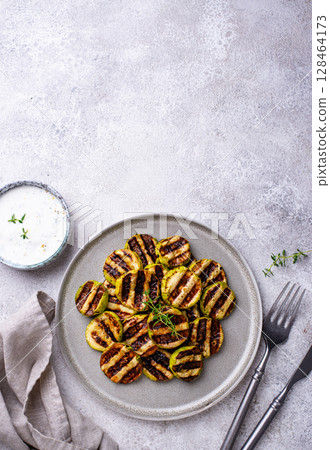 Grilled zucchini with garlic sauce 128464173