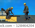 Construction Workers Installing Roof Shingles Safety Helmets Equipment 128464204