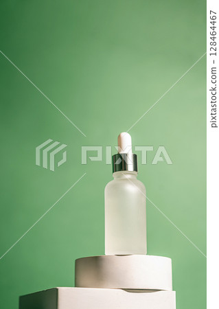 A frosted dropper bottle of facial serum 128464467