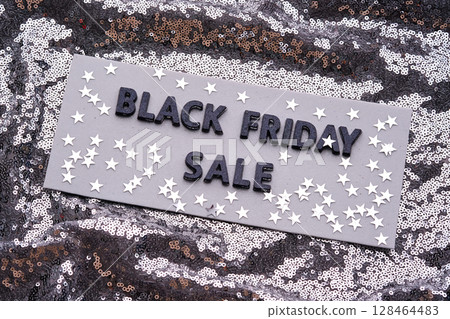 BLACK FRIDAY SALE sign on a sparkling silver sequin background. 128464483
