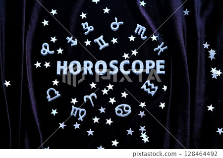 Horoscope inscription on a black velvet background. 128464492