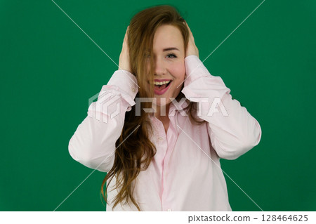 Happy and excited. Portrait of young, smiling, beautiful girl in casual clothes posing over blue studio background. Concept of youth, beauty, fashion, lifestyle, emotions, facial expression. Ad Happy and excited. Portrait of young, smiling, beautiful girl in casual clothes posing over blue studio background. Concept of youth, beauty, fashion, lifestyle, emotions, facial expression. Ad 128464625