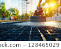 Construction site in the early morning with machinery and workers preparing for concrete pouring 128465029