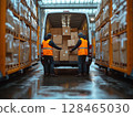 Workers load boxes into a delivery van at a warehouse during a rainy afternoon 128465030