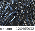Crinkled black material with shiny reflections creating an abstract texture in close-up view 128465032