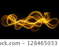 Golden light trails create a mesmerizing wave effect against a dark background 128465033