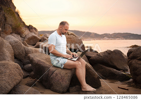 Family enjoying sunset beach time with technology and nature Family enjoying sunset beach time with technology and nature 128465086