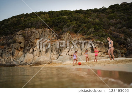 Family enjoys a sunny day at the beach filled with laughter and fun 128465093