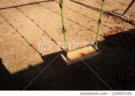 Afternoon swing, playground equipment without children Afternoon swing, playground equipment without children 128465583