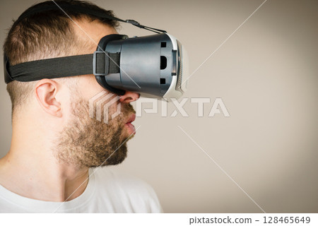 Adult man wearing vr goggles 128465649