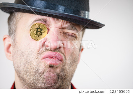 Man having bitcoin in eye 128465695