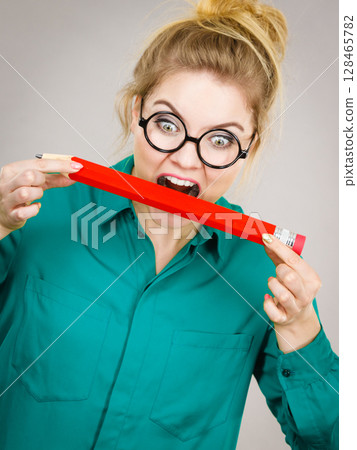 Business woman biting pencil 128465782