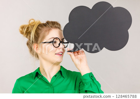 Woman holding black thinking bubble 128465788