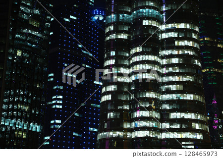 Night illuminated buildings in financial centre in Doha, Qatar Night illuminated buildings in financial centre in Doha, Qatar 128465973