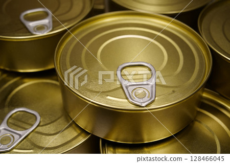 Yellow metal closed tin cans 128466045