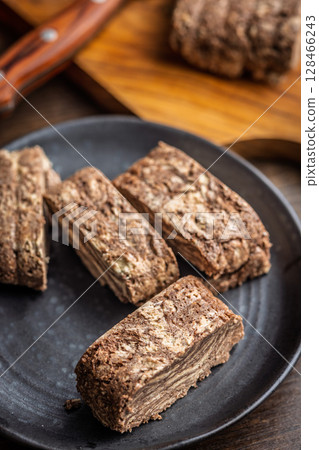 Halva with cocoa. Sweet oriental dessert on plate. Halva with cocoa. Sweet oriental dessert on plate. 128466243