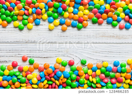 Mixed collection of colorful candy, on colored background. Flat lay, top view. frame of colorful chocolate coated candy Mixed collection of colorful candy, on colored background. Flat lay, top view. frame of colorful chocolate coated candy 128466285