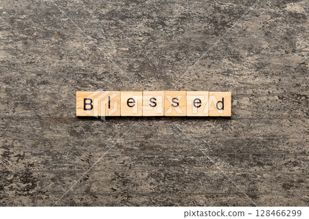 Blessed word written on wood block. Blessed text on table, concept Blessed word written on wood block. Blessed text on table, concept 128466299
