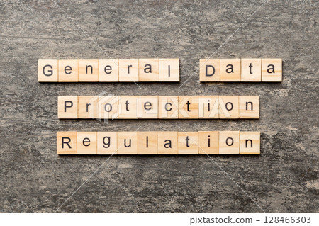 GDPR word written on wood block. General Data Protection Regulation text on cement table for your desing, concept 128466303