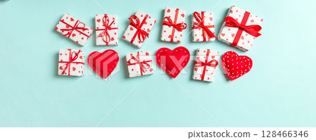Top view of gift boxes and red textile hearts on colorful background. St Valentine's day concept with copy space 128466346