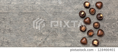 Different kinds of chocolates on colored table close-up. Top View and Flat Lay with copy space 128466401