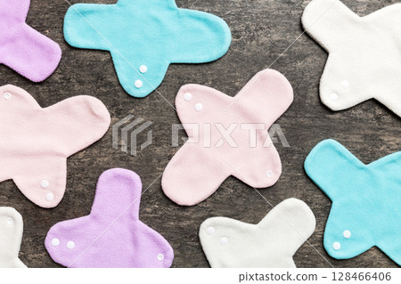 Eco-friendly reusable fabric women's pads. set of colorful bright reusable menstrual pads. zero waste woman periods concept top view with copy space Eco-friendly reusable fabric women's pads. set of colorful bright reusable menstrual pads. zero waste woman periods concept top view with copy space 128466406