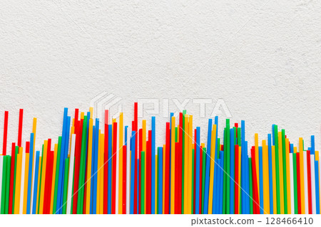 Heap of colorful plastic drinking straws on Colored background, flat lay. Copy Space for text Heap of colorful plastic drinking straws on Colored background, flat lay. Copy Space for text 128466410