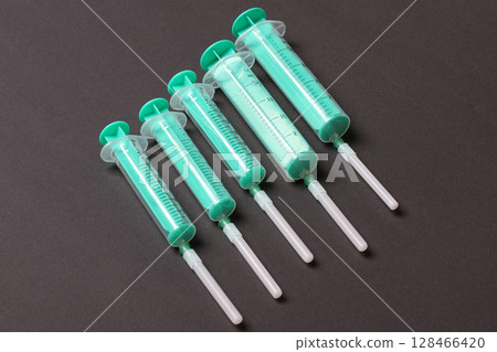 Top view of medical syringes on colorful background with copy space. Injection equipment concept 128466420