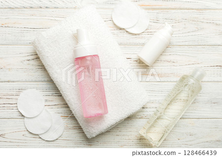 Micellar cleansing water and discs to remove cosmetics and cleanse the skin on colored background. Copy space top view 128466439