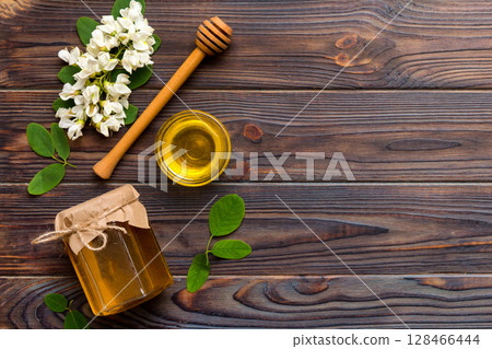 honey jar with acacia flowers and leaves. fresh honey top view flat lay 128466444