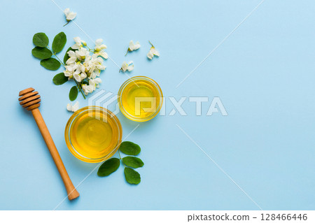 honey jar with acacia flowers and leaves. fresh honey top view flat lay honey jar with acacia flowers and leaves. fresh honey top view flat lay 128466446