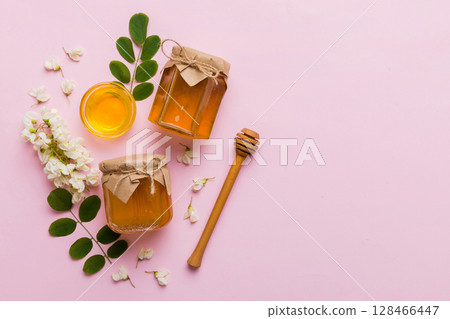 honey jar with acacia flowers and leaves. fresh honey top view flat lay honey jar with acacia flowers and leaves. fresh honey top view flat lay 128466447