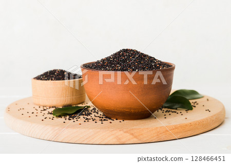 quinoa seeds in bowl on colored background. Healthy kinwa in small bowl. Healthy superfood 128466451