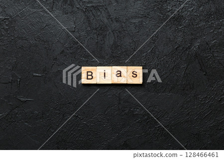 BIAS word written on wood block. BIAS text on cement table for your desing, concept 128466461