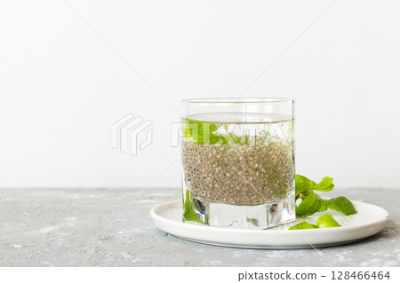 Healthy breakfast or morning with chia seeds and mint on table background, vegetarian food, diet and health concept. Chia pudding with and mint Healthy breakfast or morning with chia seeds and mint on table background, vegetarian food, diet and health concept. Chia pudding with and mint 128466464