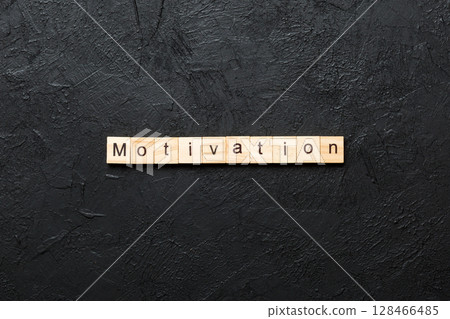 Motivation word written on wood block. Motivation text on cement table for your desing, concept 128466485