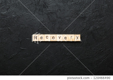 recovery word written on wood block. recovery text on table, concept recovery word written on wood block. recovery text on table, concept 128466490