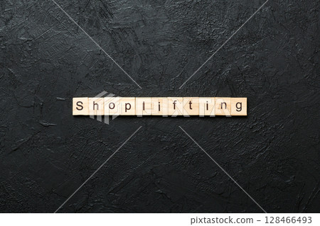 Shoplifting word written on wood block. Shoplifting text on cement table for your desing, Top view concept 128466493