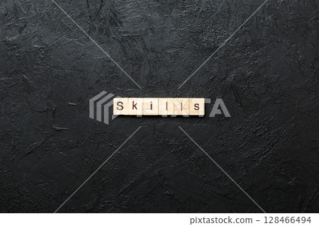 Skills word written on wood block. Skills text on cement table for your desing, concept 128466494