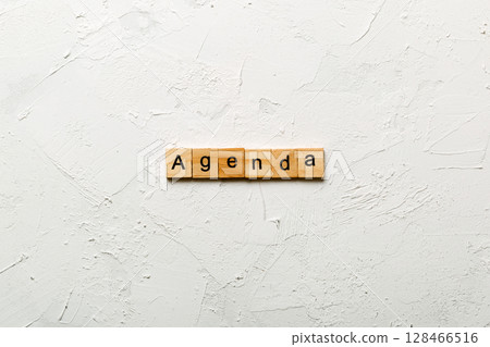 AGENDA word written on wood block. AGENDA text on cement table for your desing, concept AGENDA word written on wood block. AGENDA text on cement table for your desing, concept 128466516