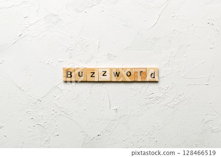 BUZZWORD word written on wood block. BUZZWORD text on cement table for your desing, concept 128466519